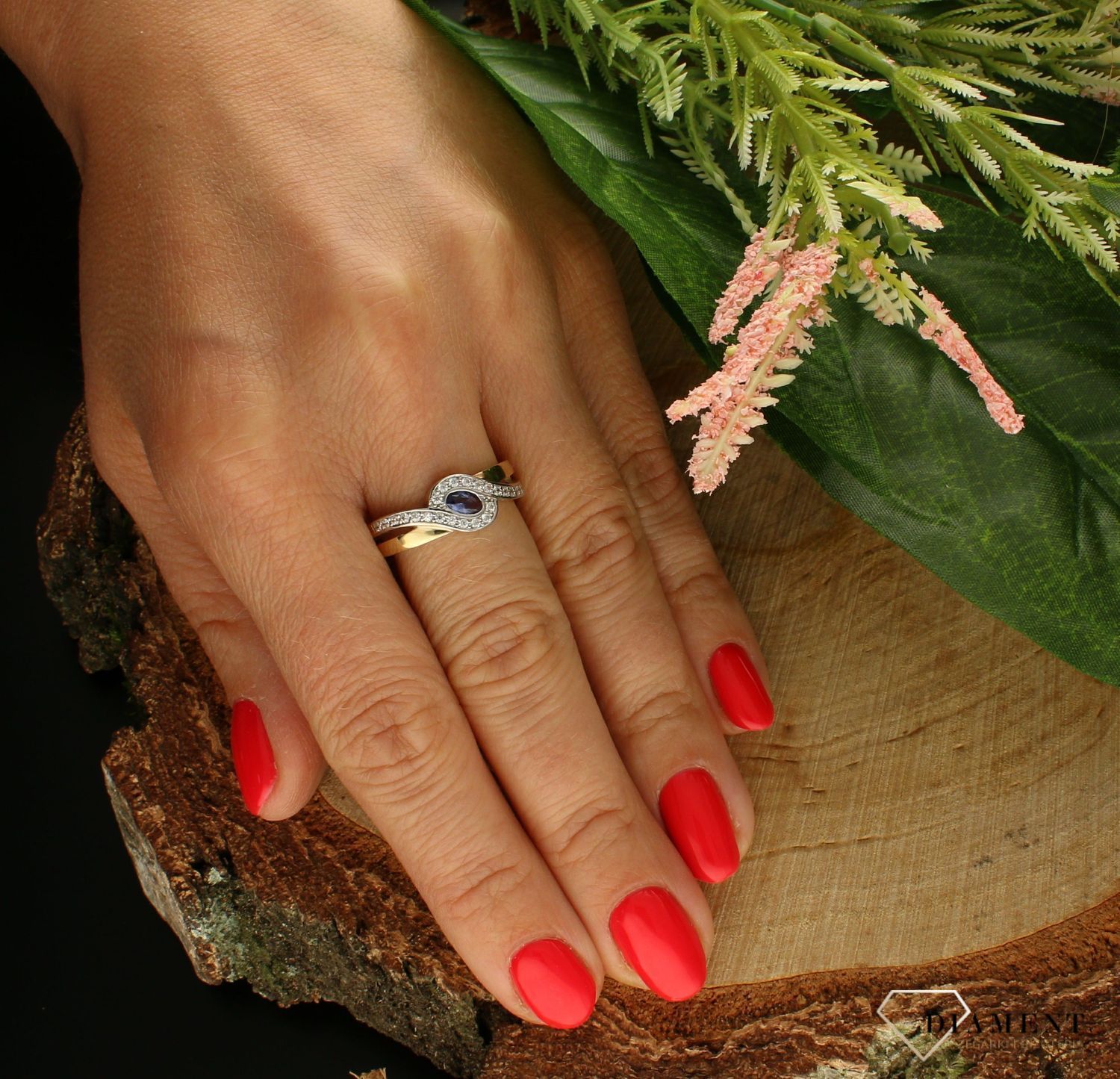 Złoty pierścionek 333 płaski z tanzanitem i cyrkoniami PI 6049C. Pierścionek został wykonany z najwyższej jakości złota próby 333. Waga pierścionka wynosi około 2,93 gram. Pierścionek został ozdobiony kamieniami naturalnymi o (1).jpg